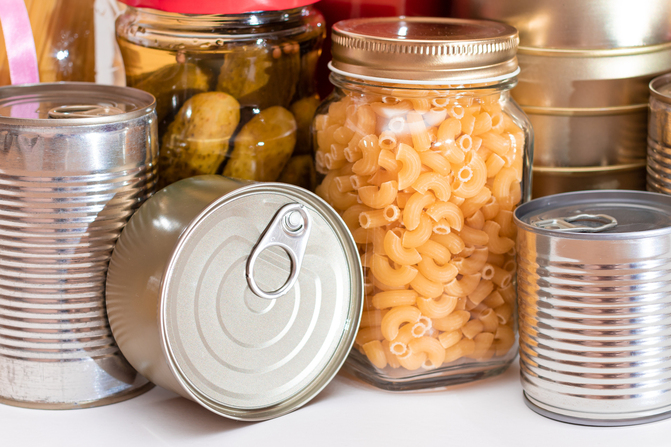 缶詰や瓶詰、乾燥パスタなどの常温保存食品をまとめて並べたストックのイメージ